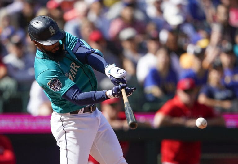 Seattle Mariners' Teoscar Hernandez hits a single to score Julio Rodriguez against the Los Angeles Angels during the fifth inning of a baseball game Wednesday