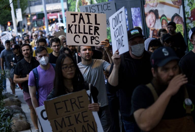 Protesters march through downtown Seattle after body camera footage was released of a Seattle police officer joking about the death of Jaahnavi Kandula