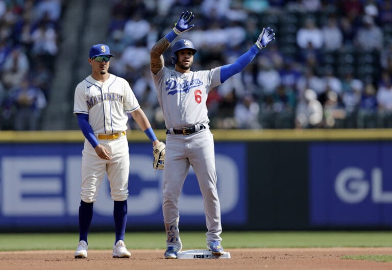 Los Angeles Dodgers' David Peralta stands on second base after reaching on a fielding error with Seattle Mariners second baseman Josh Rojas behind during the first inning of a baseball game Sunday
