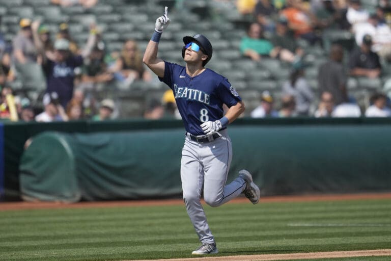 Seattle Mariners' Dominic Canzone (8) celebrates after hitting a two-run home run against the Oakland Athletics during the second inning of a baseball game in Oakland