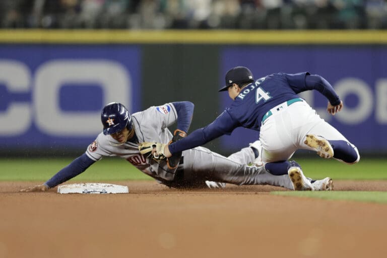 Houston Astros' Jeremy Pena is tagged out by Seattle Mariners second baseman Josh Rojas on a steal attempt during the fifth inning of a baseball game Tuesday