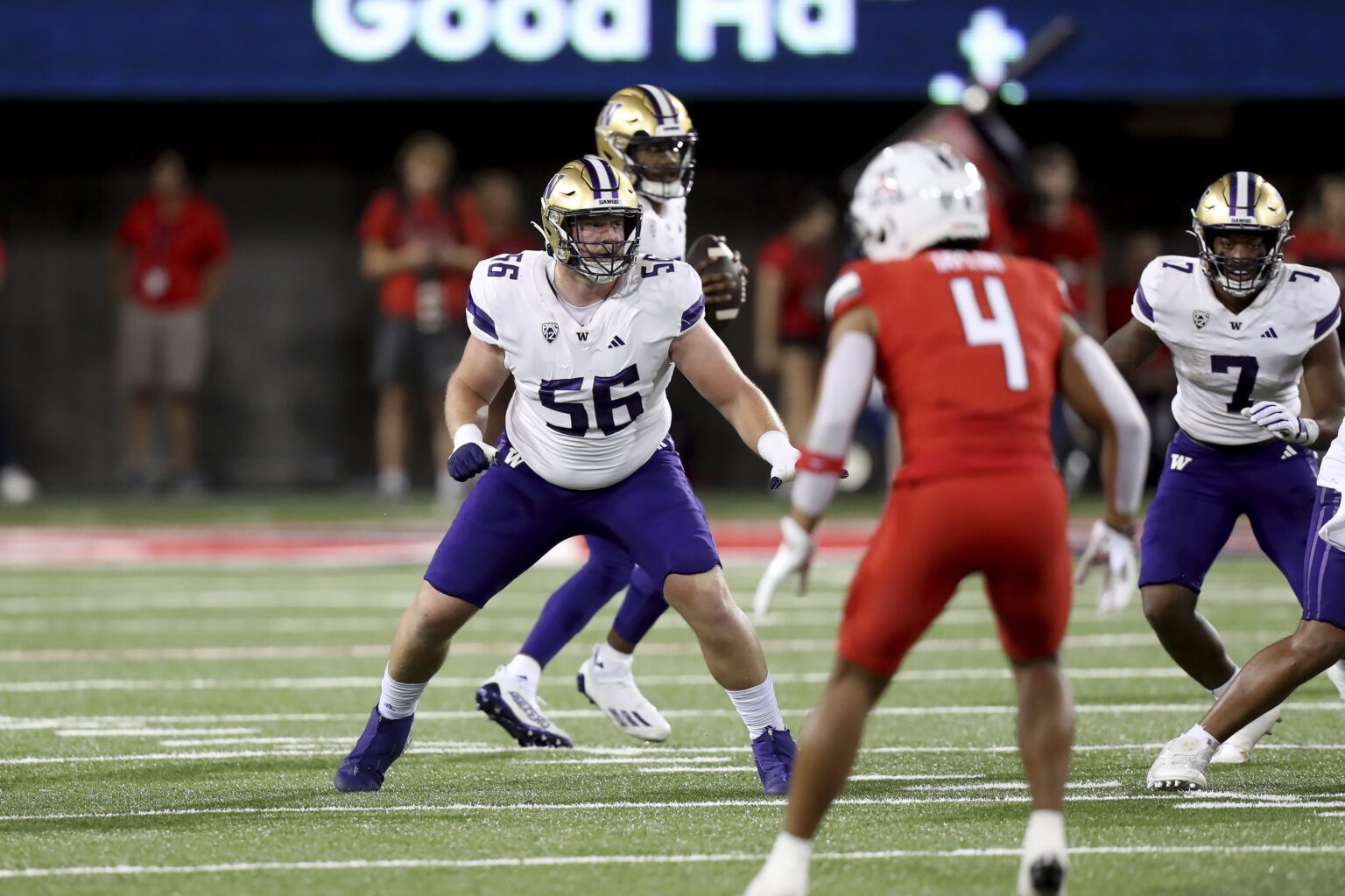 Washington Huskies offensive lineman Geirean Hatchett (56) drops into pass protection as the opposing team member gets ready.