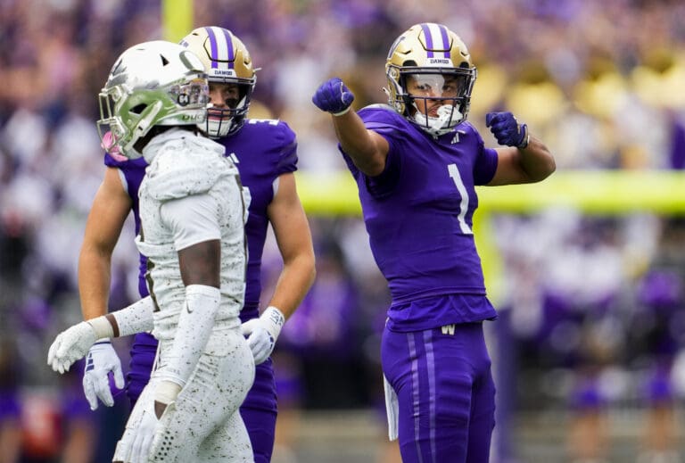 Washington wide receiver Rome Odunze (1) reacts after making a catch Saturday
