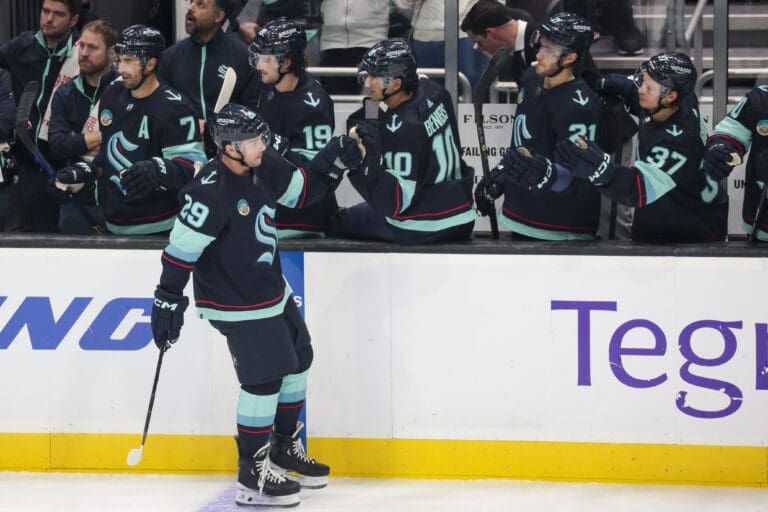 Seattle Kraken defenseman Vince Dunn (29) celebrates with the bench after his goal during the second period of an NHL hockey game against the Carolina Hurricanes