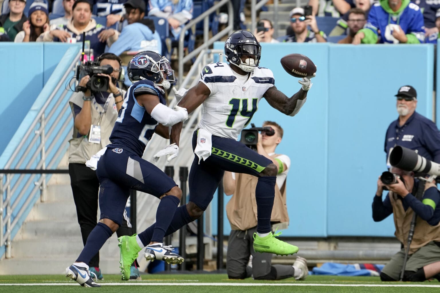 Seattle Seahawks wide receiver DK Metcalf catches a touchdown pass in front of Tennessee Titans cornerback Tre Avery as he attempts to grab onto DK Metcalf to stop him.