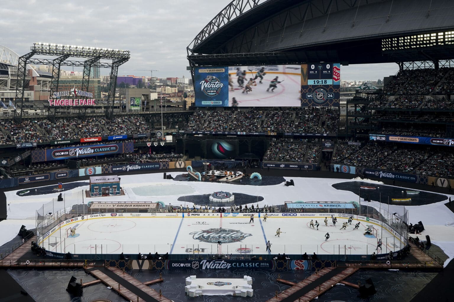 The Seattle Kraken and the Vegas Golden Knights play in the middle of T-Mobile Park surrounded by bleachers full of fans.