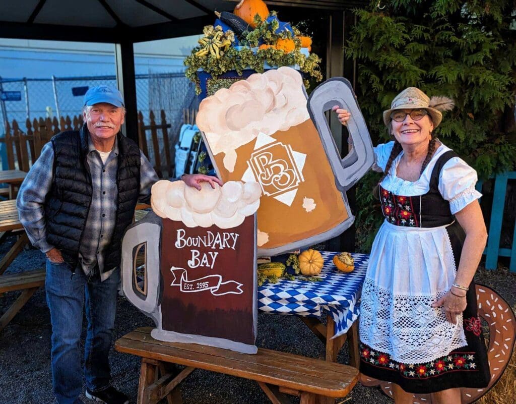 Boundary Bay Brewery owners Ed Bennett, left, and Janet Lightner hold large cutouts of beer.