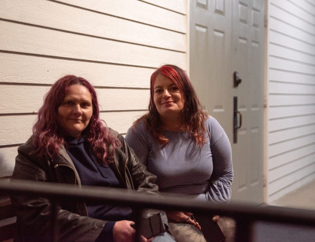 Sunshine Manderle, left, and Alisha Stevens smiles at the camera and sit outside of the Hamilton First Baptist Church.
