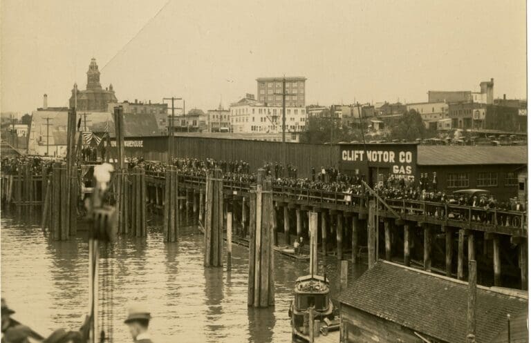 A vintage photo of people waiting at the docks.