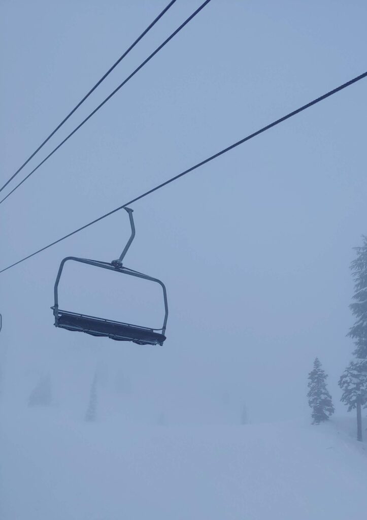 An empty Ski lift in the middle of a snowstorm.