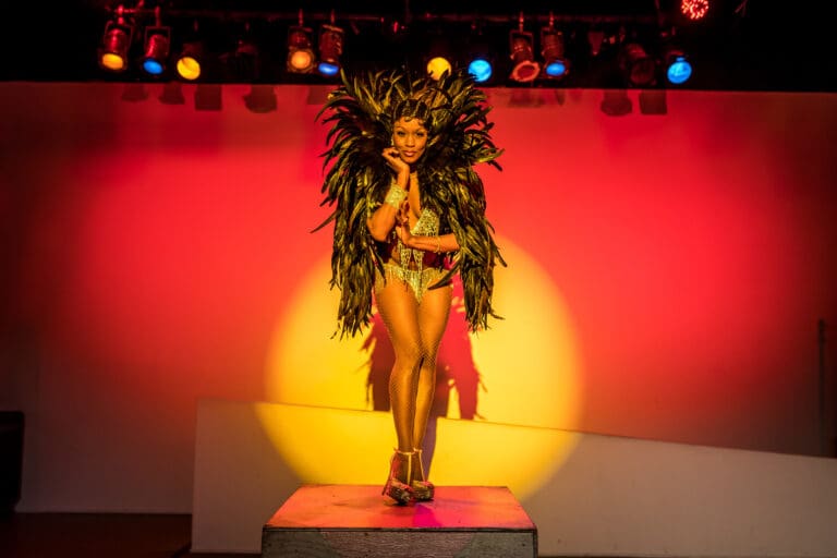Tymesha Harris performs as iconic performer Josephine Baker while donning an outfit designed with feathers.