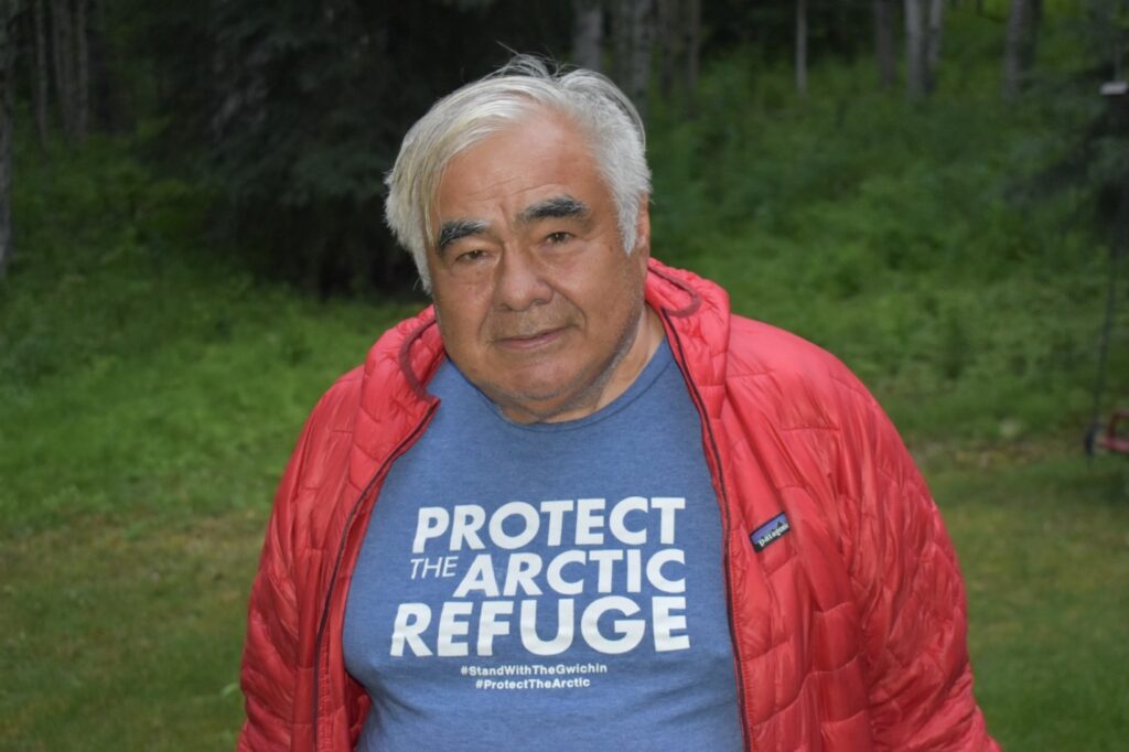 Robert Thompson wearing a blue shirt that says "Protect the Arctic Refuge", "#StandWithTheGwichin", and "#ProtectTheArtic"