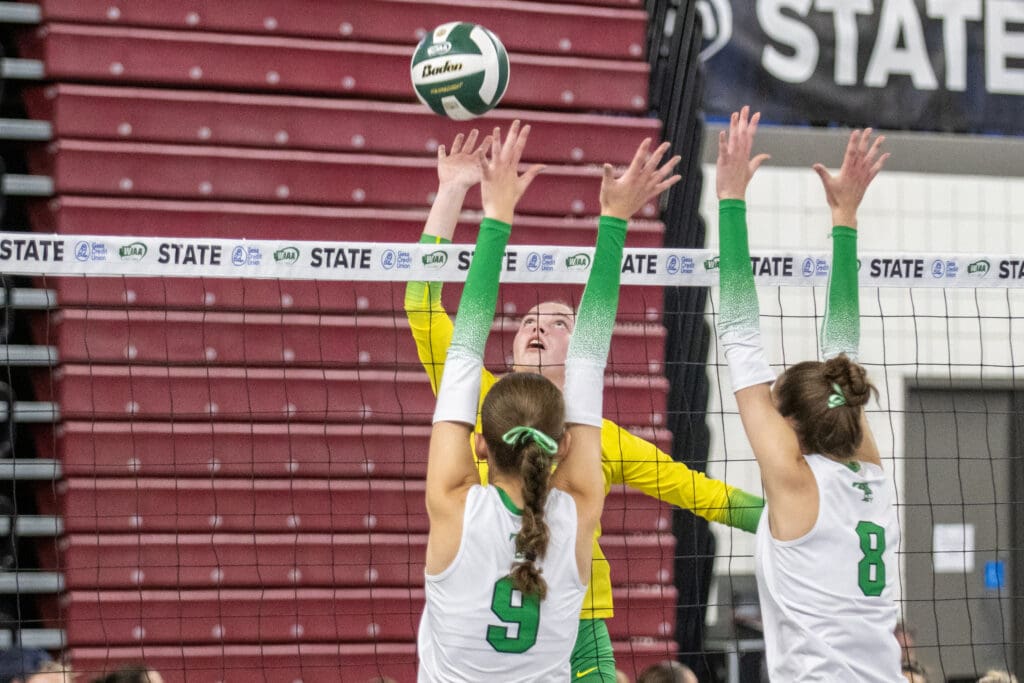 Lynden's Haylee Koetje reaches for the ball to hit over Tumwater's block.