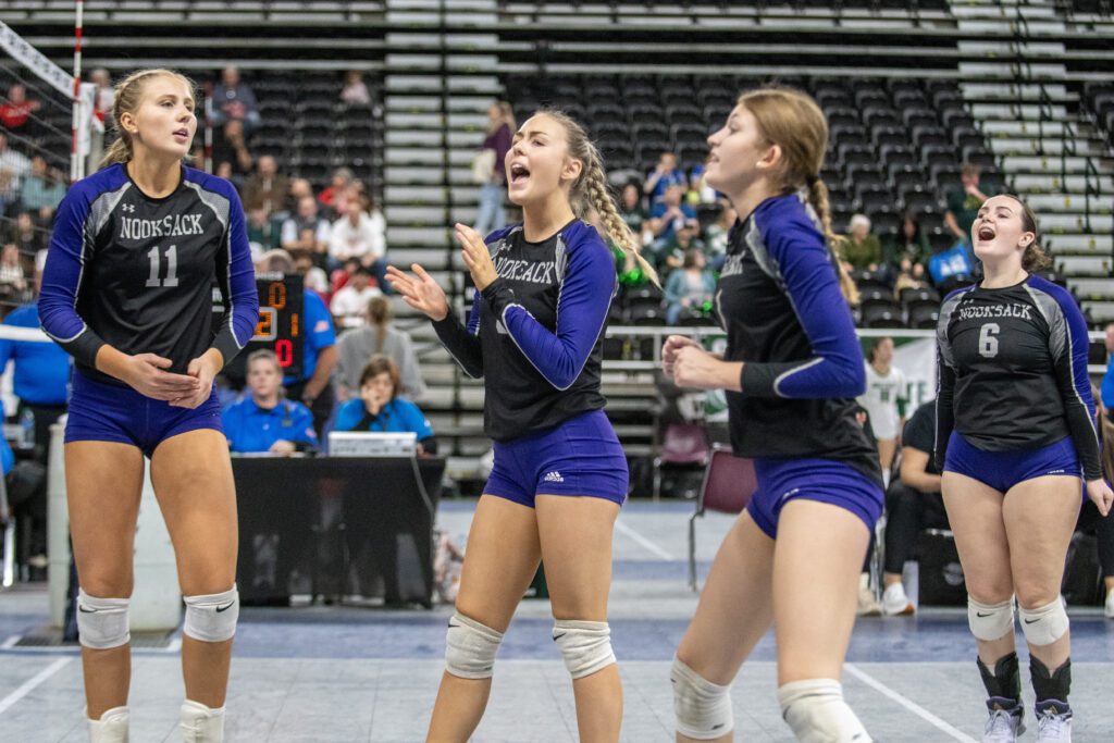 Nooksack Valley players celebrate as they clap and cheer.