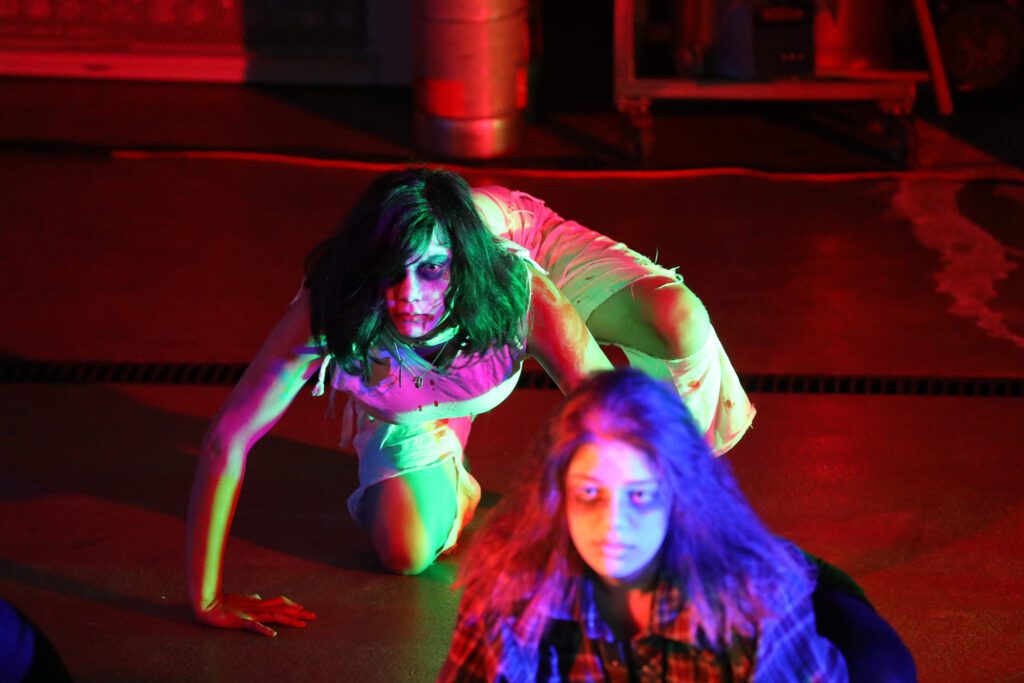 The Nightmare on Maple Street has zombies crawling on the floor with many attendees wearing makeup and tattered clothes to fit the theme.