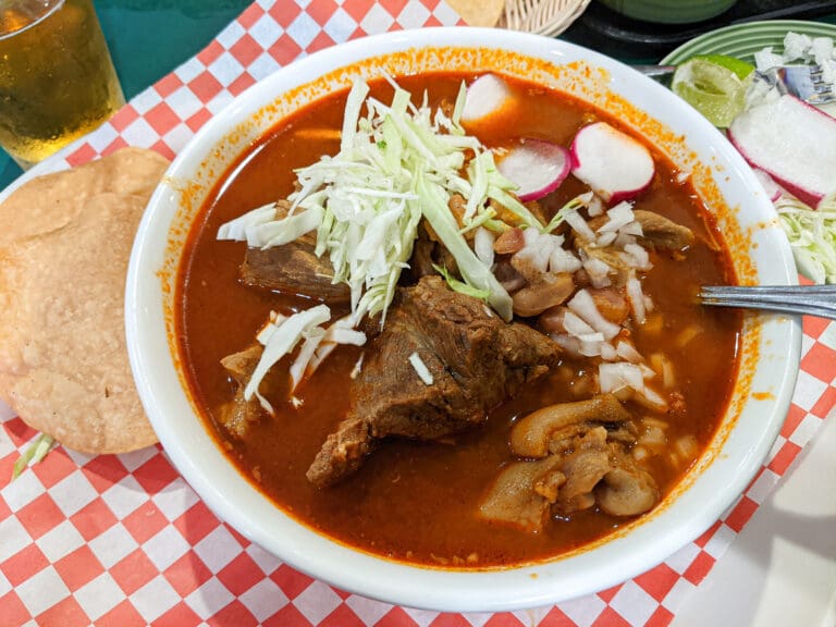 The pozole at Taqueria La Bamba is a bowl of hominy and pork soup served with tamales on the side.