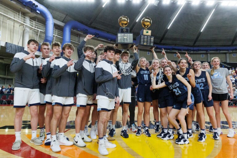 Lynden Christian  boys and girls team celebrate as both teams won their respective 1A state championship titles at the Yakima Valley SunDome on March 5, in Yakima, Wash.