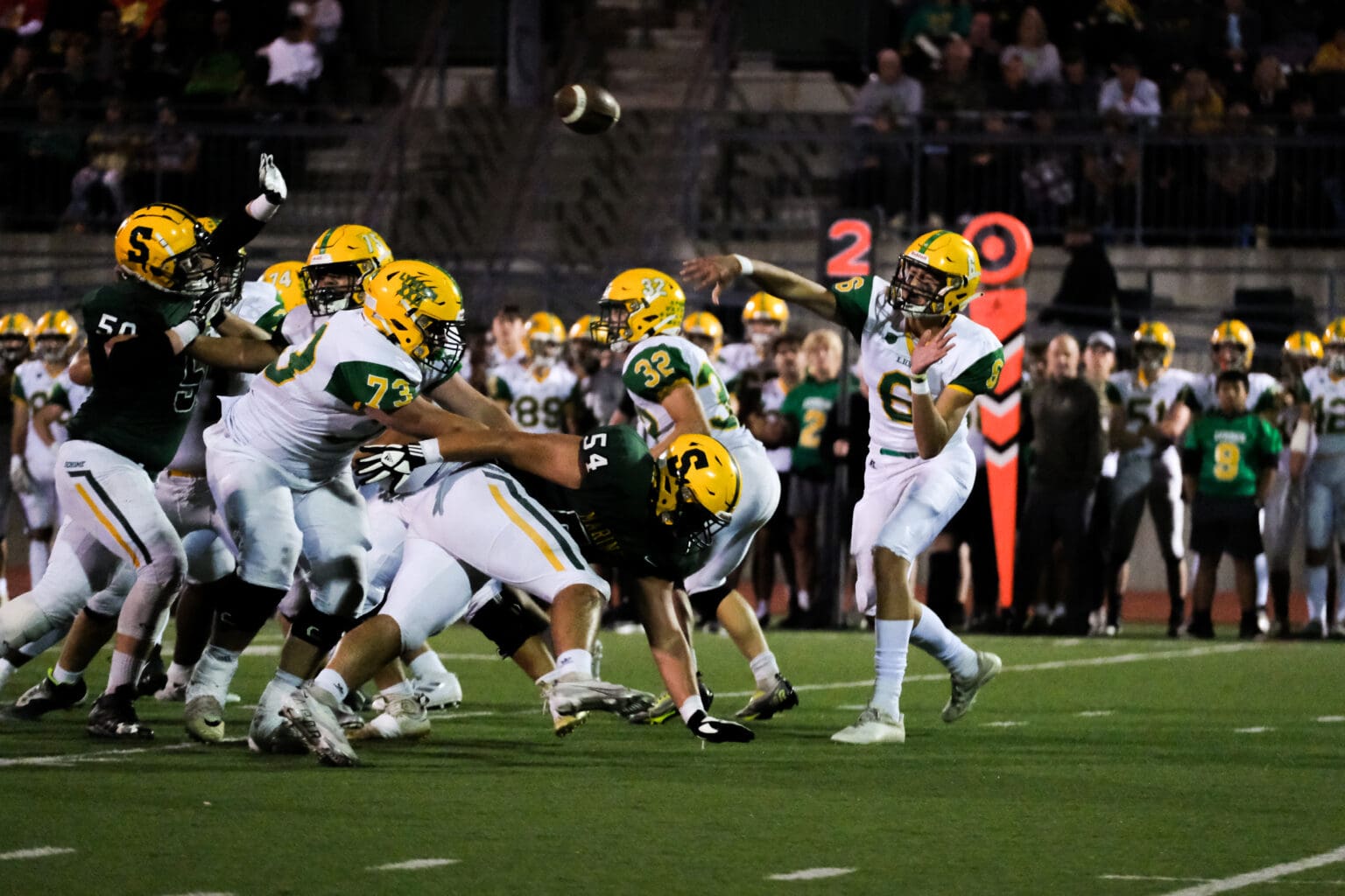 Lynden sophomore quarterback Brant Heppner throws a pass over the crowded players in front of him.