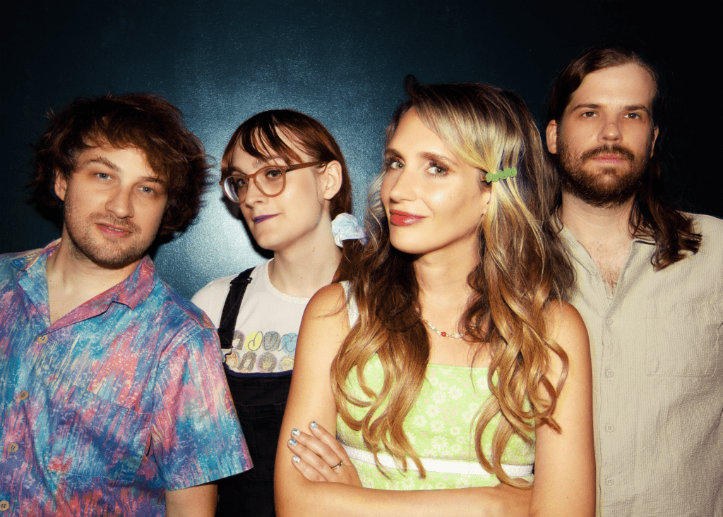 Speedy Ortiz poses for a photo on a dark blue background.