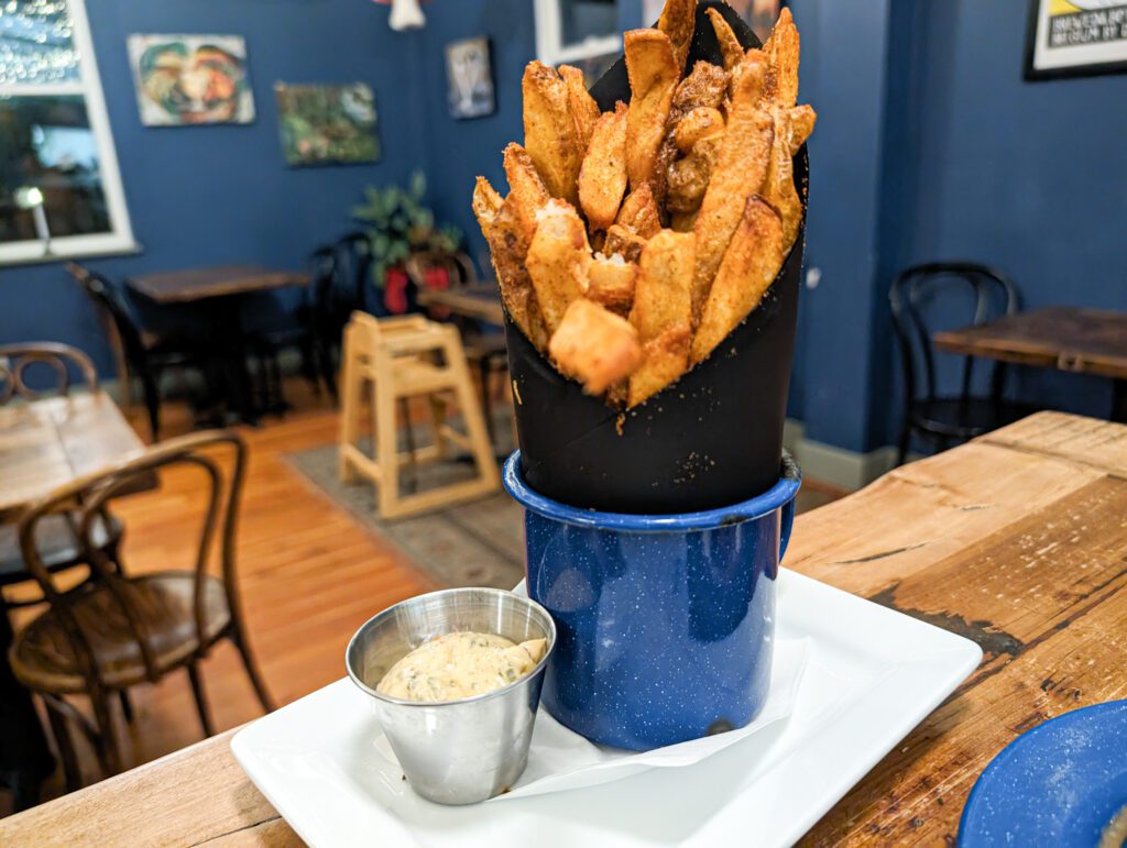 “Street frites” are hand-cut fries served with a creamy herb sauce.