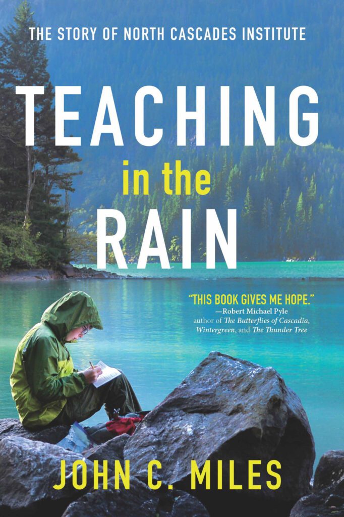 The book cover for "Teaching in the Rain" has a child writing next to a large lake.