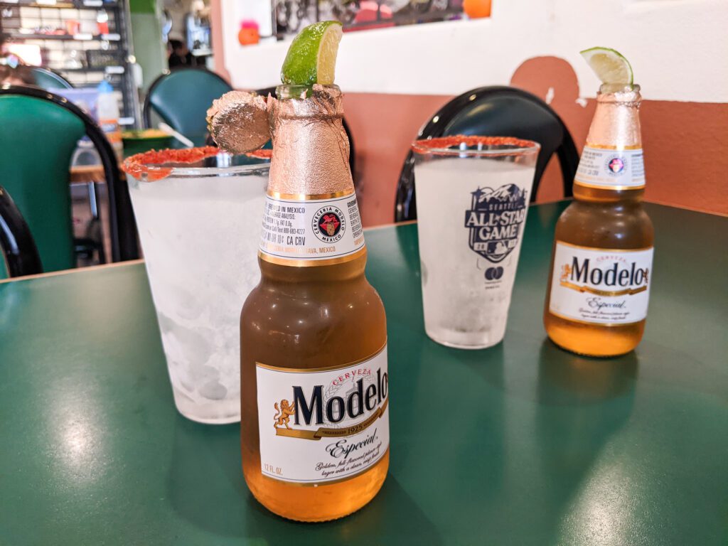 Mexican Beer, Modelo, is served with a slice of lime in the bottle and frosted glass with a chile-rim.