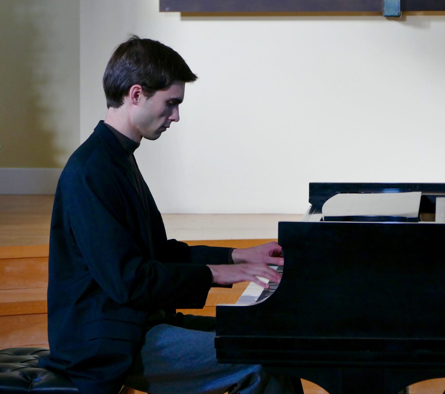 Bellingham native Cole Anderson, a prodigious pianist plays a tune on a grand piano.