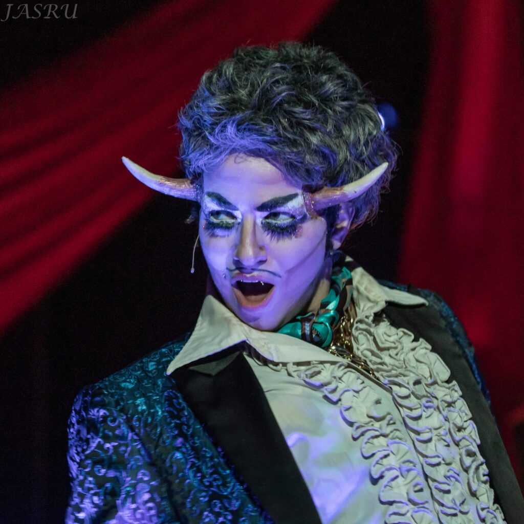 Deanna Fleysher returns to host Bellingham Circus Guild’s Beastly Frightful Unspeakably Spooky Circus of Doom with fake horns sprouting from the sides of their head.