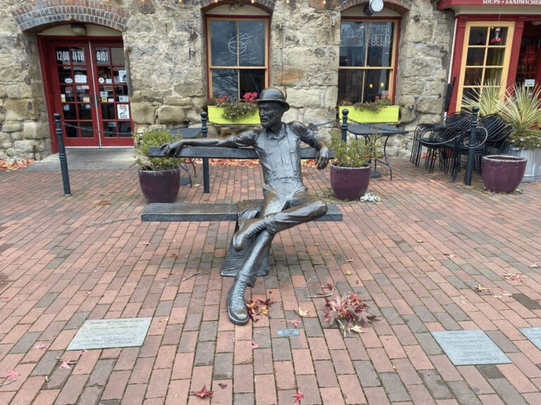 The Daniel "Dirty Dan" Harris metal statue that sits om a bench by the Fairhaven Village Green.