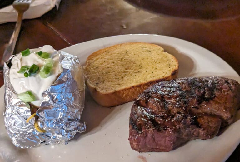 A $10 steak dinner served with garlic bread and loaded baked potatoes at Main Street Bar & Grill in Ferndale.