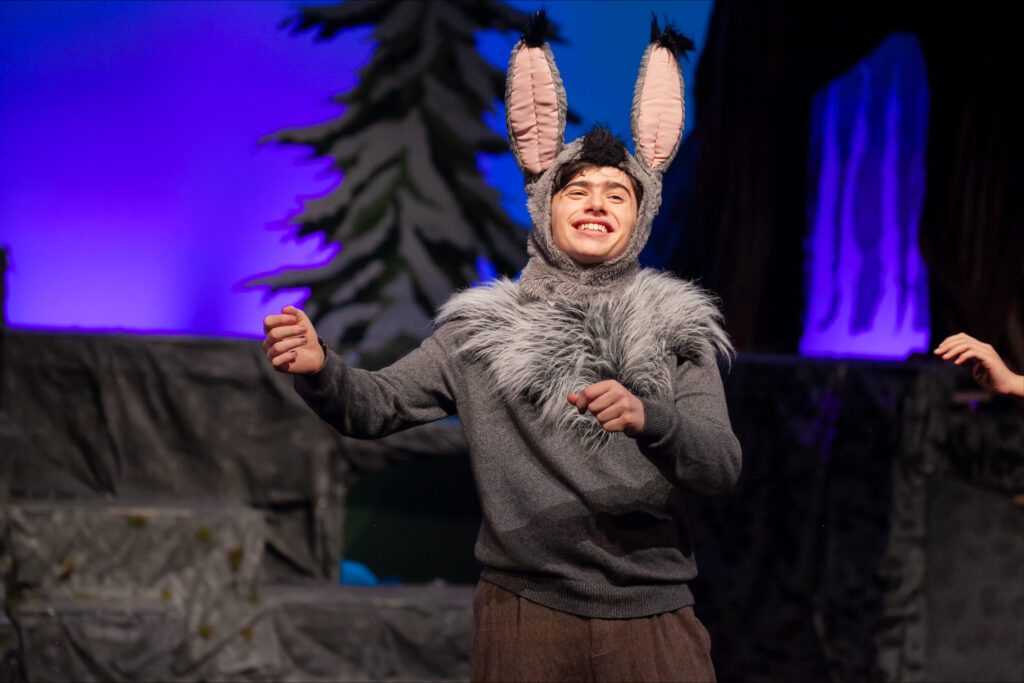 Finn Bowman plays Nick Bottom as he performs in a donkey costume.