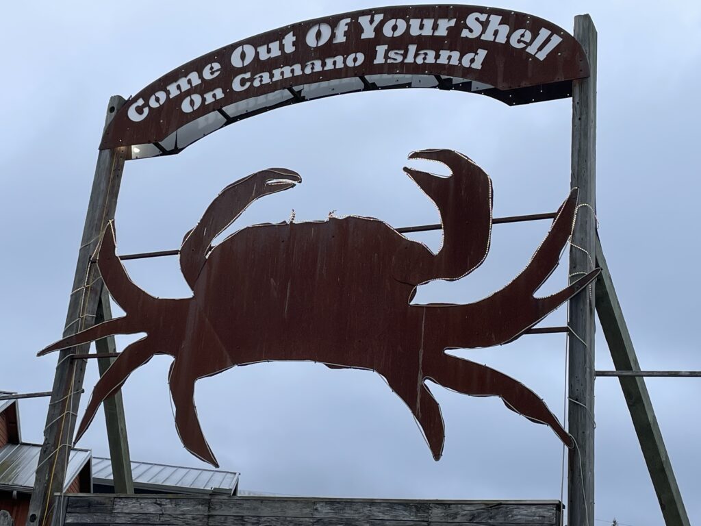 The Camano Island Commons's large outdoor sign shows a giant crab outlined with neon lights.