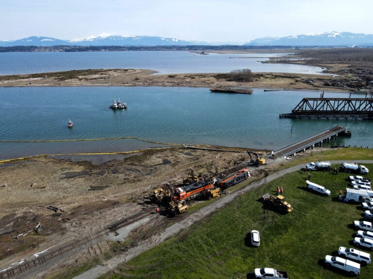The Burlington Northern Santa Fe railroad works to right a derailed freight train on the Swinomish Reservation in Anacortes on March 16. The train was headed to a nearby oil refintery and leaked an estimated 5,000 gallons of diesel after derailing.