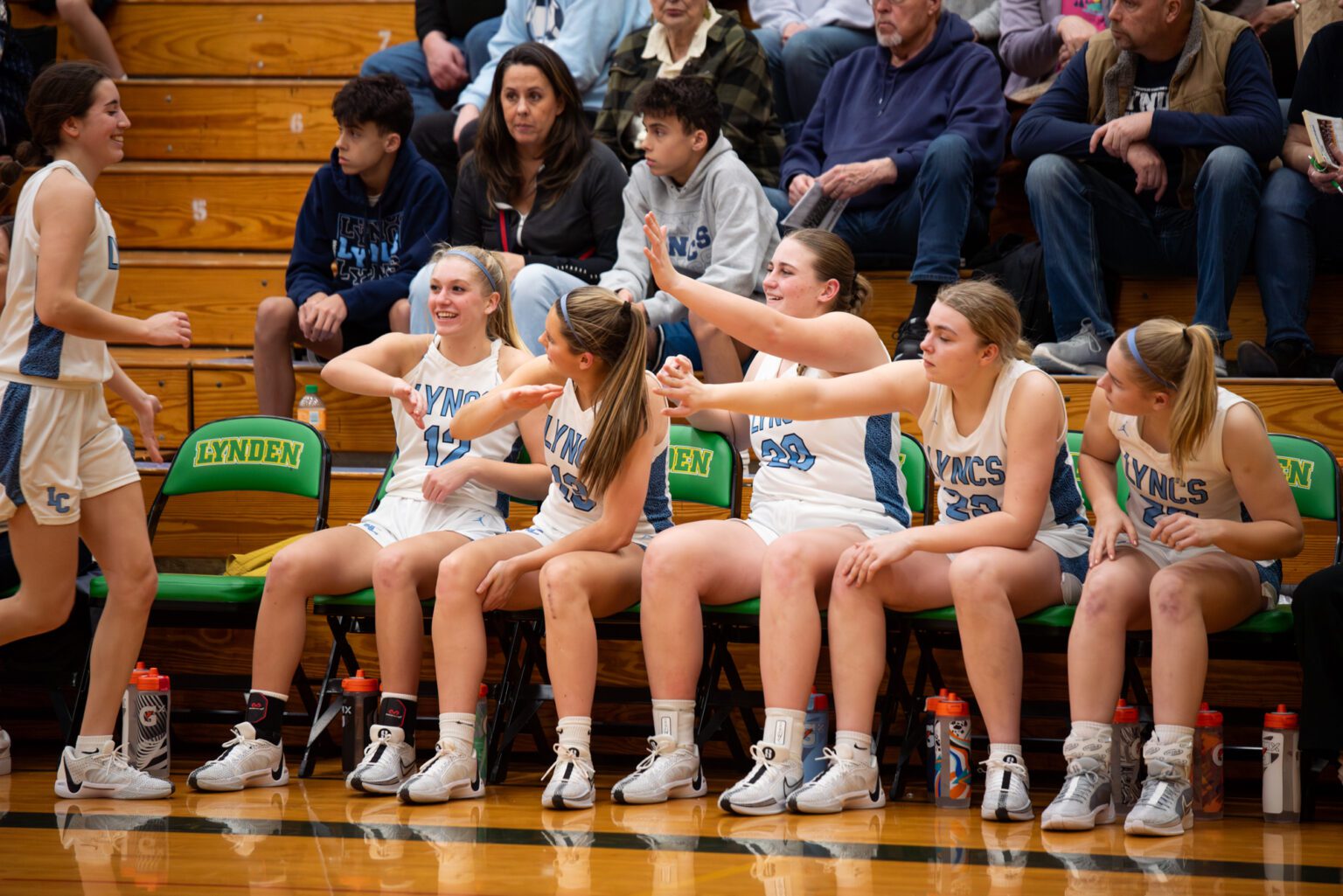 Hive-fives await Lynden Christian sophomore guard Estela Hernandez Friday, Feb. 16 as she joins the rest of the starters on the bench towards the end of the Lyncs' 62-12 win over Meridian in the 1A District 1 consolation final at Lynden High School.