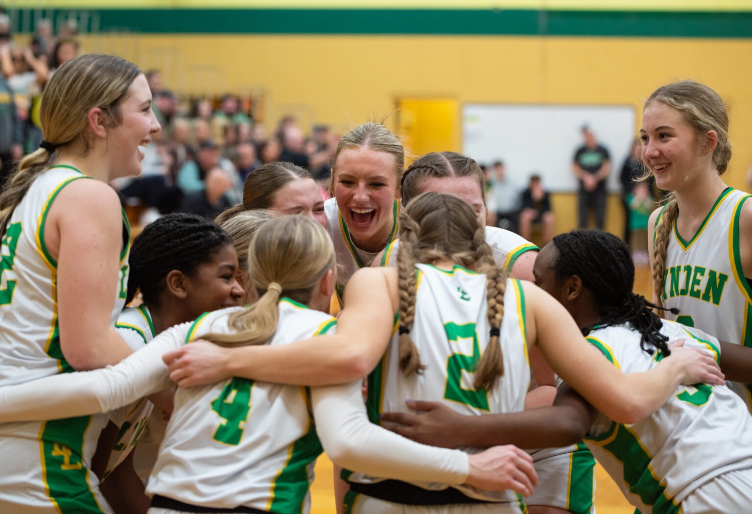 Lynden players smile during a pregame huddle Saturday, Feb. 3, before they beat Lynden Christian 66-33. Lions' freshman guard Finley Parcher, left, led the way with a game-high 19 points.