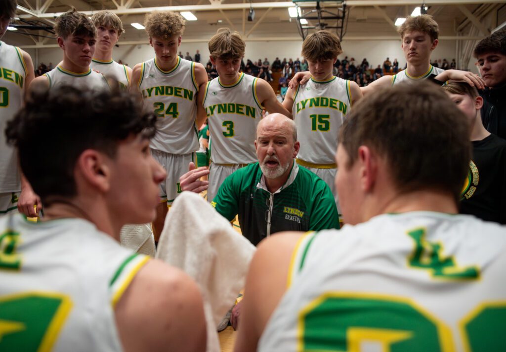Lynden head coach Brian Roper talks to the team during a timeout Wednesday, Feb. 14 in the Lions' 64-43 2A District 1 championship win over Cedarcrest at Mount Vernon High School.