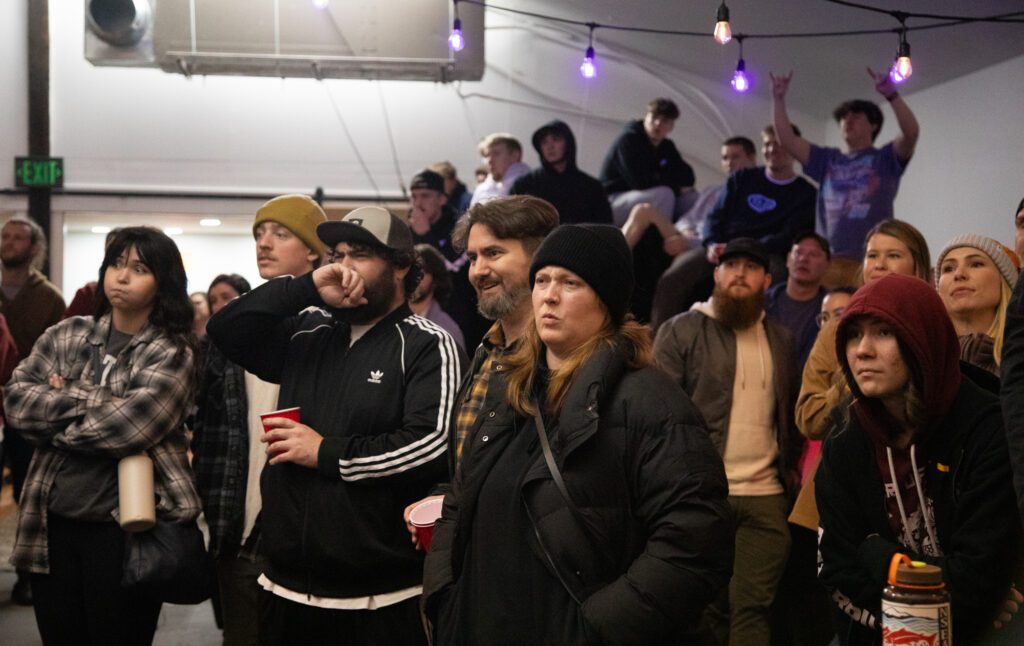 Attendees react to hard hits during a melee. Nearly 250 people attended the sold-out event.
