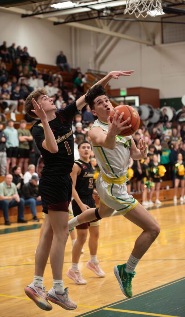Lynden senior guard Anthony Canales twists toward the rim Friday, Feb. 9 during the Lions' 62-53 win over Lakewood in the 2A District 1 semifinals at Mount Vernon High School.