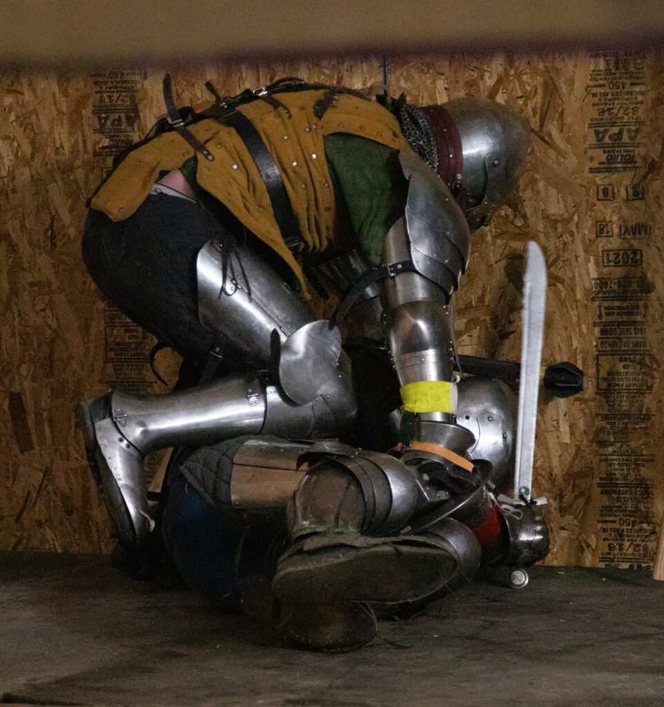 Weighing 270 pounds in armor, Daniel Morgan attempts to pin Jason Gill of the Seattle Vagabonds to the ground.