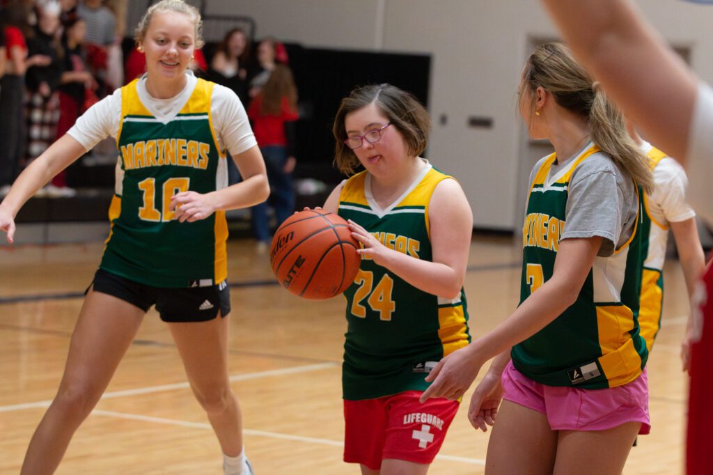 Lauren Gongwer, middle, escorts the ball to the net Wednesday, Feb. 21 with their teammates Dakota Grahn, left, and Cassidy Hogan, right during a Sehome unified basketball game against Bellingham at Bellingham High School.