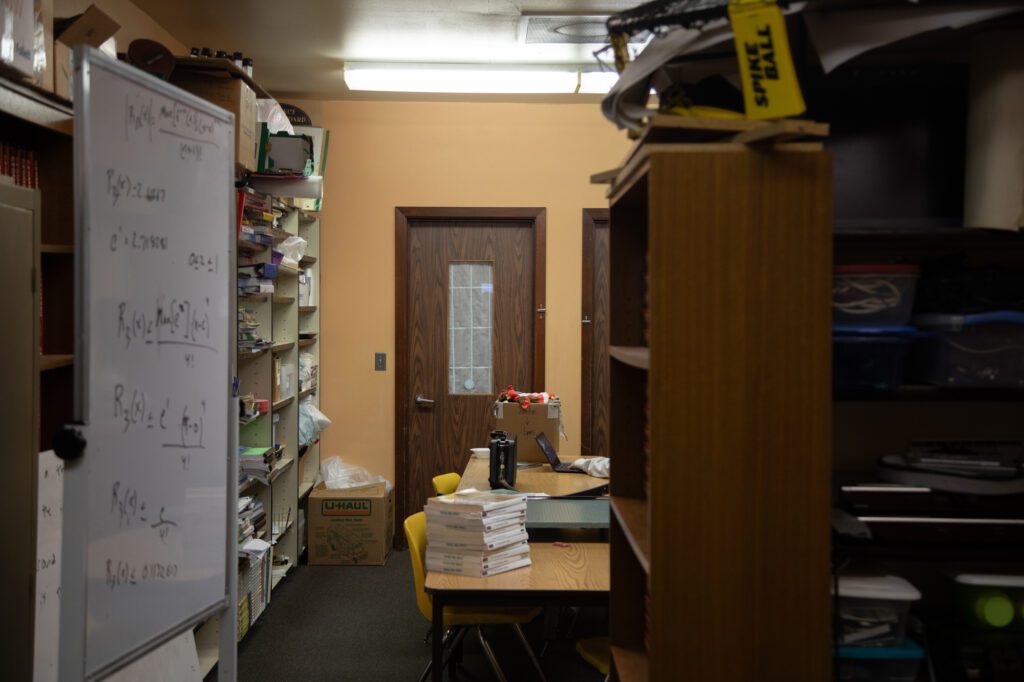 Papers and supplies cover almost every inch of available space in a staff room.