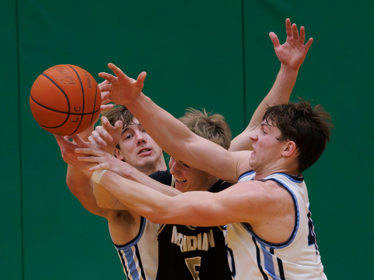 Lynden Christian’s Kayden Stuit, right, steals the ball from Meridian’s Jaeger Fyfe on Saturday, Feb. 10 during the Lyncs' 71-58 win over the Trojans in the 1A District 1 title game at Lynden High School.