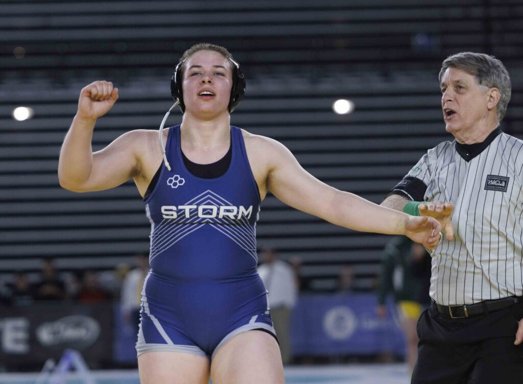 Squalicum senior Bella Phillips raises their arm after winning the girls 1B/2B/1A/2A 190-pound state championship Saturday, Feb. 17, during Mat Classic XXXV at the Tacoma Dome.