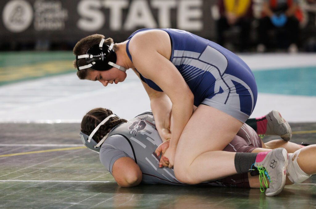 Squalicum’s Bella Phillips puts an arm bar on their opponent before pinning her Saturday, Feb. 17 during day two of Mat Classic XXXV at the Tacoma Dome.