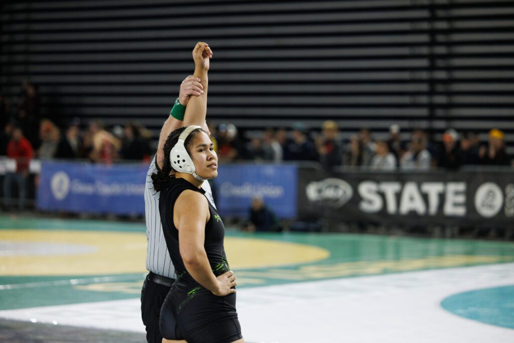 Lynden’s Belen Lopez has her arm raised after beating Toppenish’s Islah Alcala for third place.