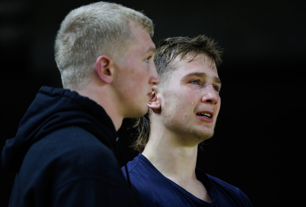 A tear rolls down the cheek of Mount Baker’s Daniel Washburn as his brother, Elijah Washburn, talks to him after losing to Cashmere’s Hugh Wheeler in a 1A 157-pound championship.