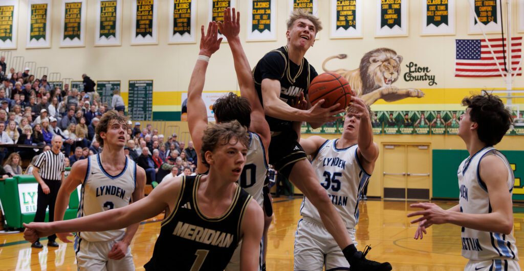 Meridian’s Jaeger Fyfe leaps for a shot in traffic Saturday, Feb. 10 during the Trojans' 71-58 loss to Lynden Christian in the 1A District 1 title game at Lynden High School.
