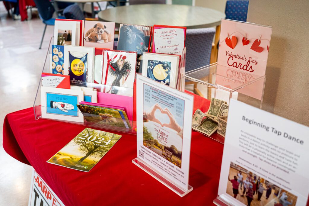 Valentine's Day cards are displayed beside a poster for "The Age of Love" on Feb. 6 at the Bellingham Senior Activity Center.