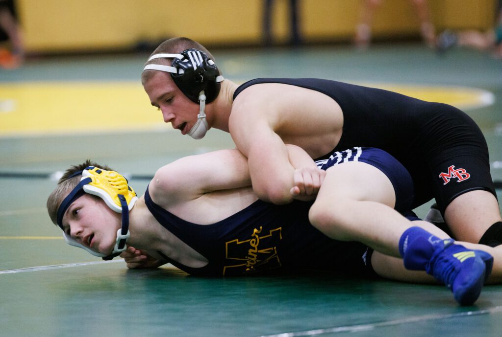 Daniel Washburn tries to keep his opponent on the ground by entangling their arms together.