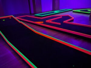 Mammoth Mini Golf’s 18 holes glow under black light, as seen on Feb. 17 during its soft opening in Bellis Fair mall. 